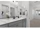 Contemporary bathroom featuring dual mirrors, gray cabinets, white countertops, and matte black hardware at 2149 W Rowel Rd, Phoenix, AZ 85085