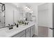 A modern bathroom with double sinks, gray cabinets, matte black fixtures, and a large mirror at 2149 W Rowel Rd, Phoenix, AZ 85085