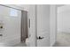 This bathroom features a shower with gray curtain, toilet, and a bright window at 2149 W Rowel Rd, Phoenix, AZ 85085