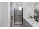 Modern bathroom featuring a glass shower and gray cabinets with white countertops at 2149 W Rowel Rd, Phoenix, AZ 85085