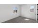 This is a vacant bedroom featuring plush gray carpeting and natural light from the large windows at 2149 W Rowel Rd, Phoenix, AZ 85085