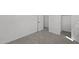 Vacant bedroom with closet and ensuite with white walls, gray carpet and white trim at 2149 W Rowel Rd, Phoenix, AZ 85085