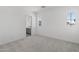 Bright bedroom with neutral carpet, featuring a large window and a connecting bathroom for convenience at 2149 W Rowel Rd, Phoenix, AZ 85085