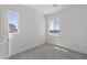 This is a vacant bedroom featuring plush gray carpeting and natural light from the large windows at 2149 W Rowel Rd, Phoenix, AZ 85085