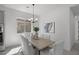 Cozy dining room featuring a wooden table, comfortable seating, and plenty of natural light, ideal for Gathering meals at 2149 W Rowel Rd, Phoenix, AZ 85085