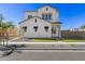 Charming two-story home featuring white siding, a well-manicured lawn, and contemporary architectural details at 2149 W Rowel Rd, Phoenix, AZ 85085