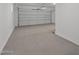 Clean, well-lit two-car garage with a large white door and concrete floor at 2149 W Rowel Rd, Phoenix, AZ 85085