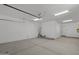 Spacious two-car garage with white walls, concrete floor, and overhead lighting at 2149 W Rowel Rd, Phoenix, AZ 85085