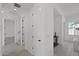 Clean, bright hallway with neutral tile flooring offers seamless transition between rooms in the home at 2149 W Rowel Rd, Phoenix, AZ 85085