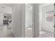 Hallway featuring an open doorway and view of the dining area and kitchen with modern tile floors at 2149 W Rowel Rd, Phoenix, AZ 85085