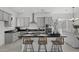 Modern kitchen featuring sleek countertops, stainless steel appliances, and an island with seating for casual dining at 2149 W Rowel Rd, Phoenix, AZ 85085