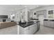 Well-designed kitchen showcasing an island with sink, sleek countertops, and an open connection to the living area at 2149 W Rowel Rd, Phoenix, AZ 85085