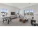 Living room featuring large windows, natural light, and a recreational game table at 2149 W Rowel Rd, Phoenix, AZ 85085