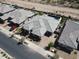 Aerial view of a modern home with desert landscaping, its private driveway, and neighboring properties at 22867 E Via Las Brisas --, Queen Creek, AZ 85142