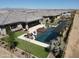 Aerial view of a modern home with desert landscaping and a pool, spa, outdoor kitchen, and manicured backyard at 22867 E Via Las Brisas --, Queen Creek, AZ 85142