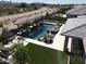 Aerial view of a modern home with a resort-style pool, spa, outdoor kitchen, and manicured backyard at 22867 E Via Las Brisas --, Queen Creek, AZ 85142