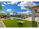 The lush backyard boasts a pool, well-manicured turf, and a fire pit area at 22867 E Via Las Brisas --, Queen Creek, AZ 85142