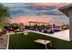 An inviting backyard features a pool, turf, and a fire pit at 22867 E Via Las Brisas --, Queen Creek, AZ 85142
