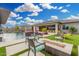 Beautiful backyard with a sparkling pool, a fire pit and lush green grass at 22867 E Via Las Brisas --, Queen Creek, AZ 85142