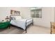 Cozy bedroom with a metal bed frame, bright window, and soft natural light at 22867 E Via Las Brisas --, Queen Creek, AZ 85142
