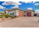 Charming home with a brick driveway, two-car garage and desert landscaping at 22867 E Via Las Brisas --, Queen Creek, AZ 85142