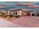 Charming home with a brick driveway, two-car garage and desert landscaping at 22867 E Via Las Brisas --, Queen Creek, AZ 85142