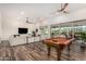 Spacious game room featuring a classic pool table, comfortable seating, and sliding glass doors to the outdoor space at 22867 E Via Las Brisas --, Queen Creek, AZ 85142