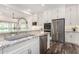 Close-up of kitchen featuring stainless steel appliances, granite countertops and stylish white cabinetry at 22867 E Via Las Brisas --, Queen Creek, AZ 85142
