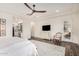 Bright main bedroom with stylish decor, ensuite access, and a ceiling fan at 22867 E Via Las Brisas --, Queen Creek, AZ 85142