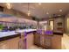 The outdoor kitchen has a grill, a bar, and a view of the pool at twilight at 22867 E Via Las Brisas --, Queen Creek, AZ 85142