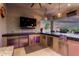 This gorgeous outdoor kitchen features stainless steel appliances, a sink, and a bar at 22867 E Via Las Brisas --, Queen Creek, AZ 85142