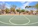 Community basketball court with well-maintained lines and trees, suitable for recreational games at 2307 E Pecan Rd, Phoenix, AZ 85040