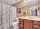 Bathroom featuring vanity with sink, mirror, towel rack, toilet, and shower behind curtain at 2307 E Pecan Rd, Phoenix, AZ 85040