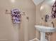 Half bathroom featuring a pedestal sink, decorative mirror, and neutral paint at 2307 E Pecan Rd, Phoenix, AZ 85040