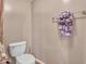 Clean half bathroom showcases a toilet, towel rack, and tiled flooring at 2307 E Pecan Rd, Phoenix, AZ 85040
