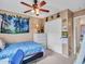 Comfortable bedroom with a ceiling fan, closet, a bed with floral bedding, paired with a white dresser at 2307 E Pecan Rd, Phoenix, AZ 85040