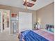 Inviting bedroom with a ceiling fan, a window, and a bed with patterned bedding, along with a closet and side table at 2307 E Pecan Rd, Phoenix, AZ 85040