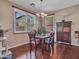 Cozy dining room featuring a wood table, chandelier, and natural light from large windows at 2307 E Pecan Rd, Phoenix, AZ 85040
