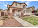 Two-story home boasts a covered porch with seating, surrounded by manicured landscaping and a cozy neighborhood at 2307 E Pecan Rd, Phoenix, AZ 85040