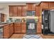 Updated kitchen with stainless steel appliances, wood cabinets, and granite countertops at 2307 E Pecan Rd, Phoenix, AZ 85040