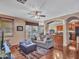 Cozy living room with hardwood floors, ample seating, and an open view to the kitchen area at 2307 E Pecan Rd, Phoenix, AZ 85040