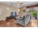 Comfortable living room featuring hardwood floors, a plush sofa, and sliding glass doors to the backyard at 2307 E Pecan Rd, Phoenix, AZ 85040