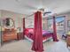 Main bedroom with four-poster bed, side tables, ceiling fan, and natural light from window at 2307 E Pecan Rd, Phoenix, AZ 85040