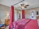 Well-lit main bedroom featuring a ceiling fan, large bed, and view to the rest of the house at 2307 E Pecan Rd, Phoenix, AZ 85040