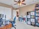 Home office featuring ceiling fan, work desk, shelving unit, and view of hallway at 2307 E Pecan Rd, Phoenix, AZ 85040