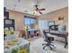 Office space with desk, rolling chair, window, ceiling fan, and storage for organization at 2307 E Pecan Rd, Phoenix, AZ 85040