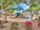 Charming community playground, nestled between mature shade trees and blooming bushes that offers outdoor fun for families at 2307 E Pecan Rd, Phoenix, AZ 85040