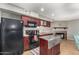 Well-designed kitchen with stainless steel island and fireplace in attached room at 2315 W Union Hills Dr # 124, Phoenix, AZ 85027
