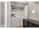 Bright laundry room features front load washer and dryer, overhead storage, and gray accents at 2315 W Union Hills Dr # 124, Phoenix, AZ 85027