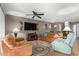 Open-concept living space with ceiling fan, entertainment center, and modern furnishings at 2315 W Union Hills Dr # 124, Phoenix, AZ 85027